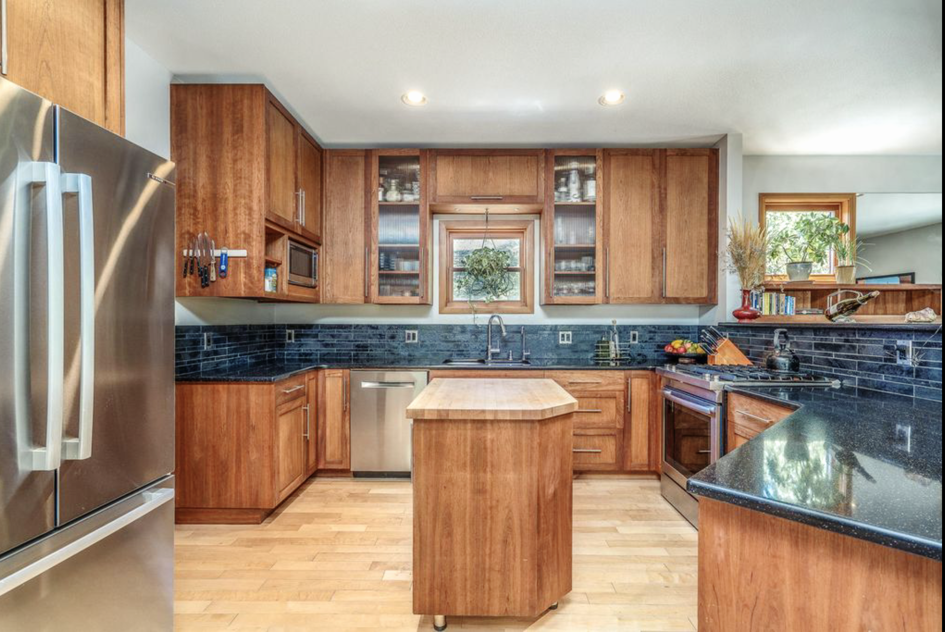 Open-concept remodeled kitchen connecting to the dining and living areas