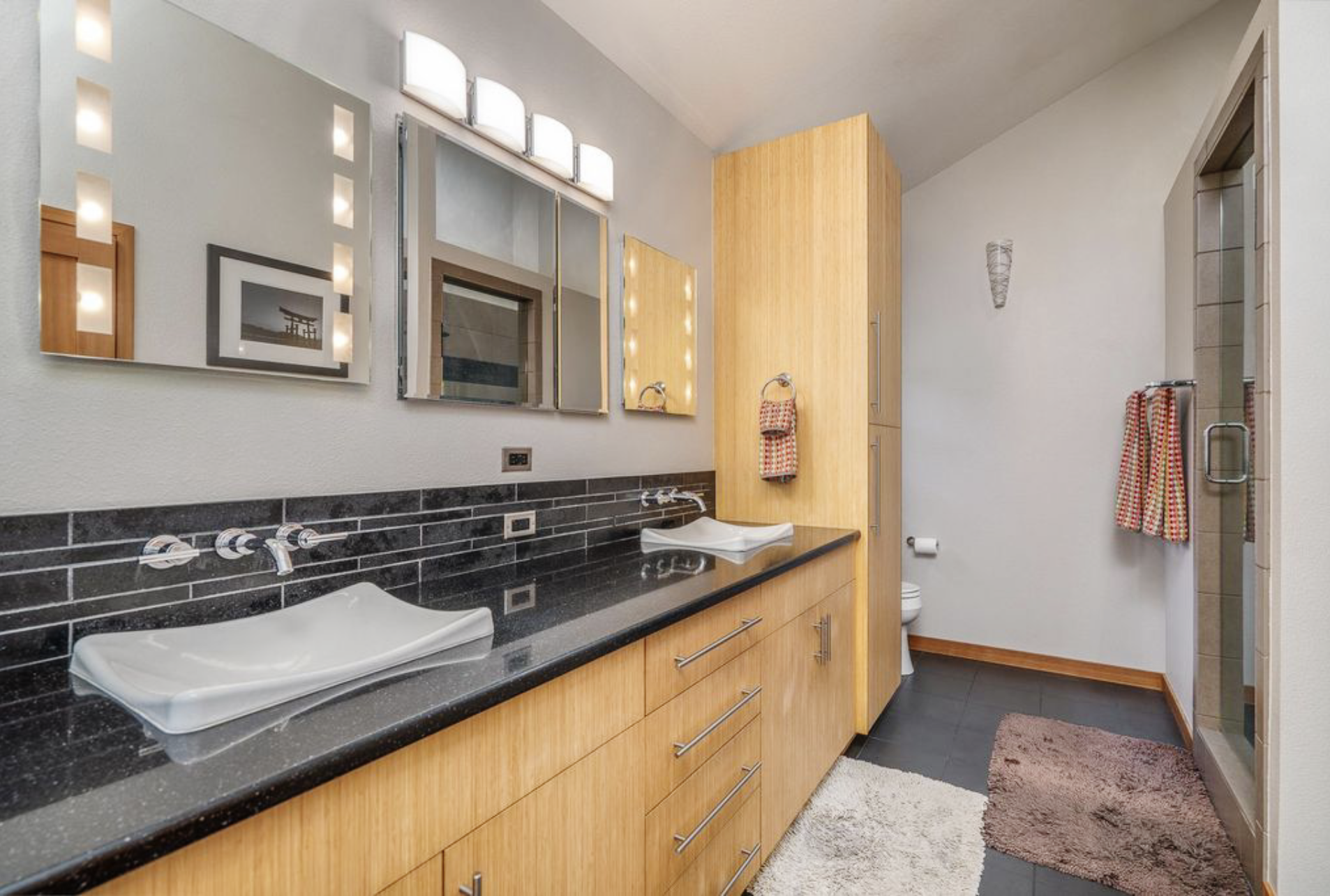 Custom bathroom remodel with vanity, tile and walk-in shower by Alchemy Builders Inc